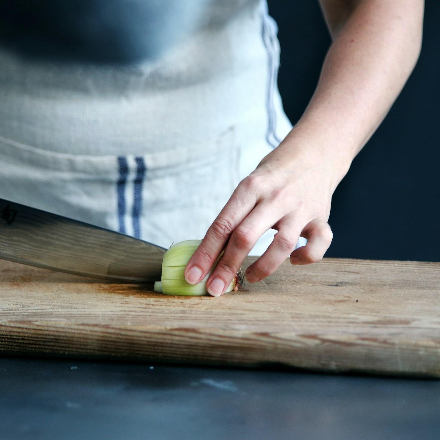 Community members collaborating in a modern kitchen space, sharing recipes and cooking techniques